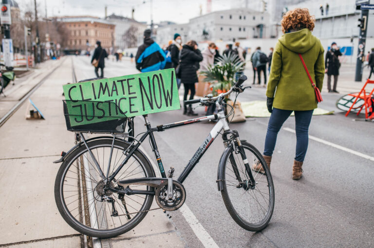 Climate Justice Now sign on a bike at a rally against climate change 51059099596 1