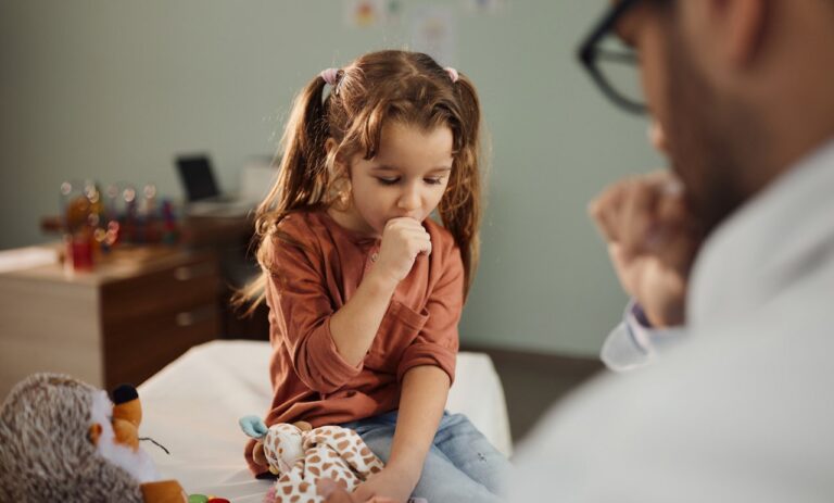 child coughing at doctor