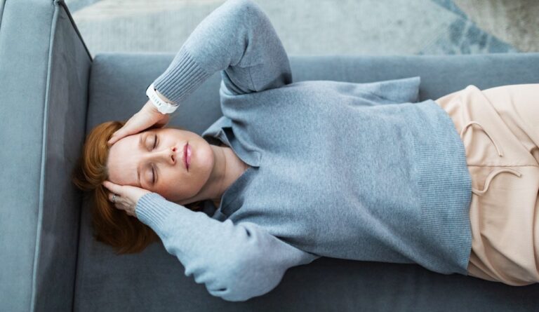 woman laying down headache